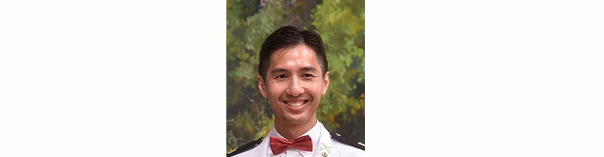 Portrait of Leow Kah Shin, man smiling in a white suit and red bowtie